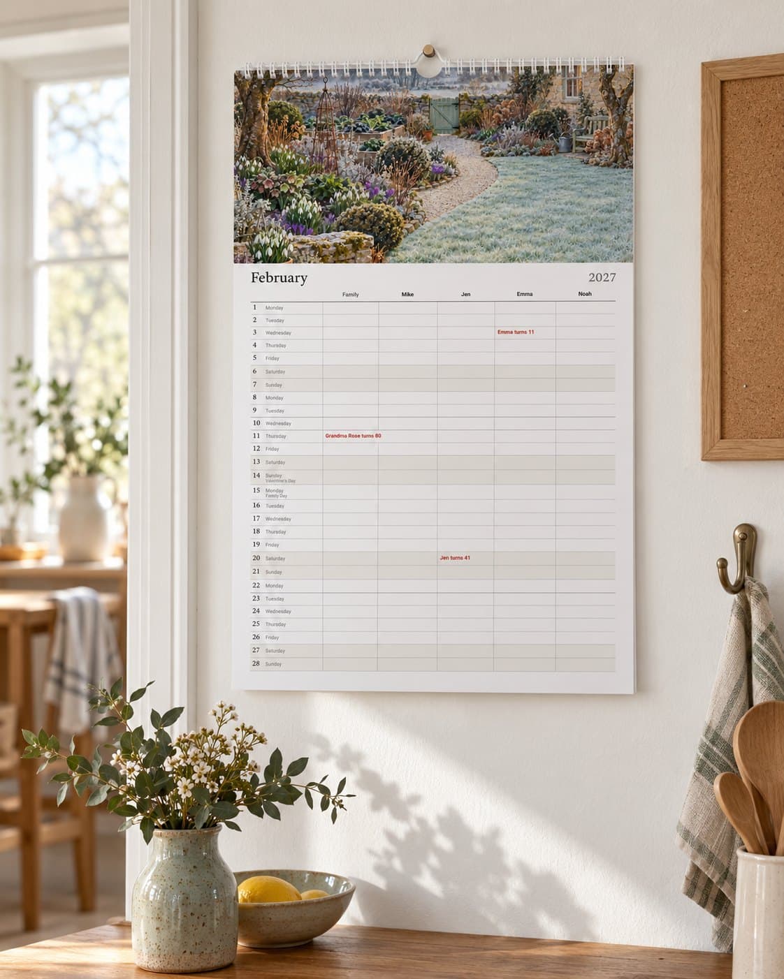 The family calendar with a column for each person, hanging in a kitchen