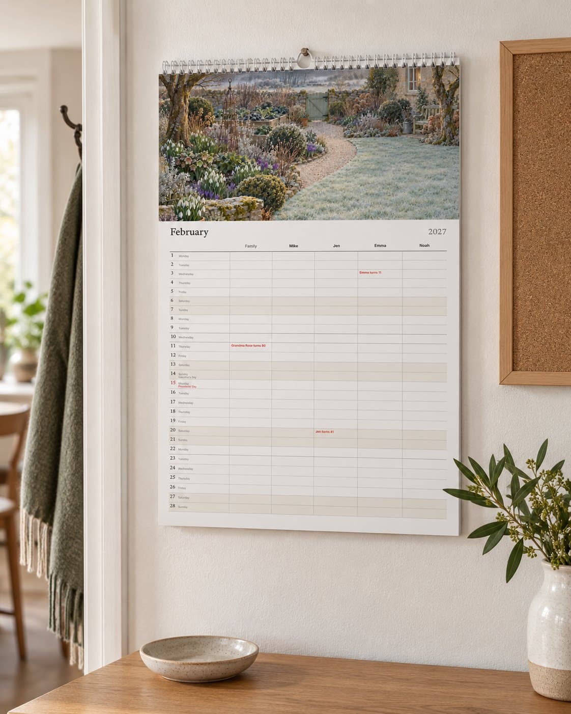 The family calendar with a column for each person, hanging in a kitchen