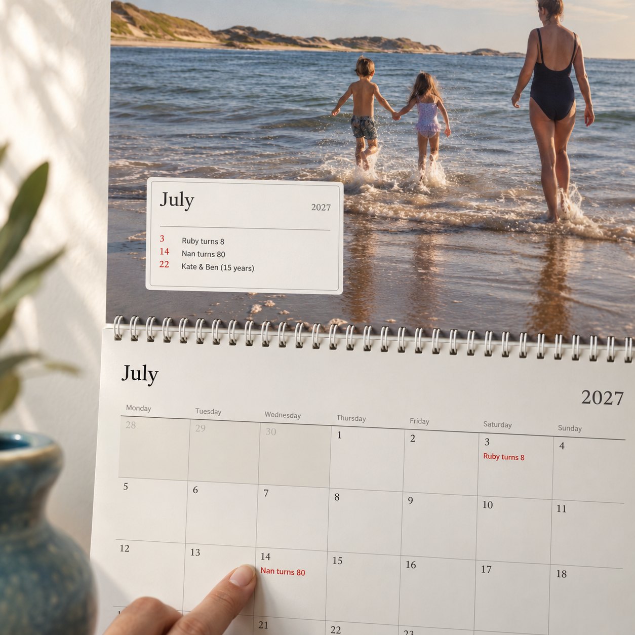 Close-up of the photo calendar: the month's box lists who is celebrating, and a finger points to grandma's 80th