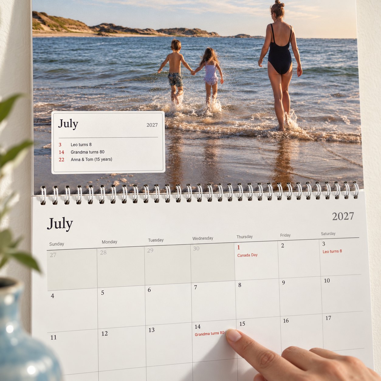 Close-up of the photo calendar: the month's box lists who is celebrating, and a finger points to grandma's 80th